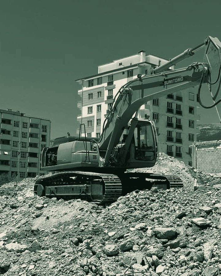 Excavator on demolition rubble